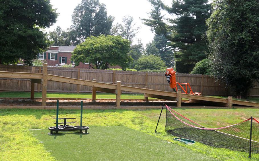 Workout stations are placed on the field around "The Bro Barn"