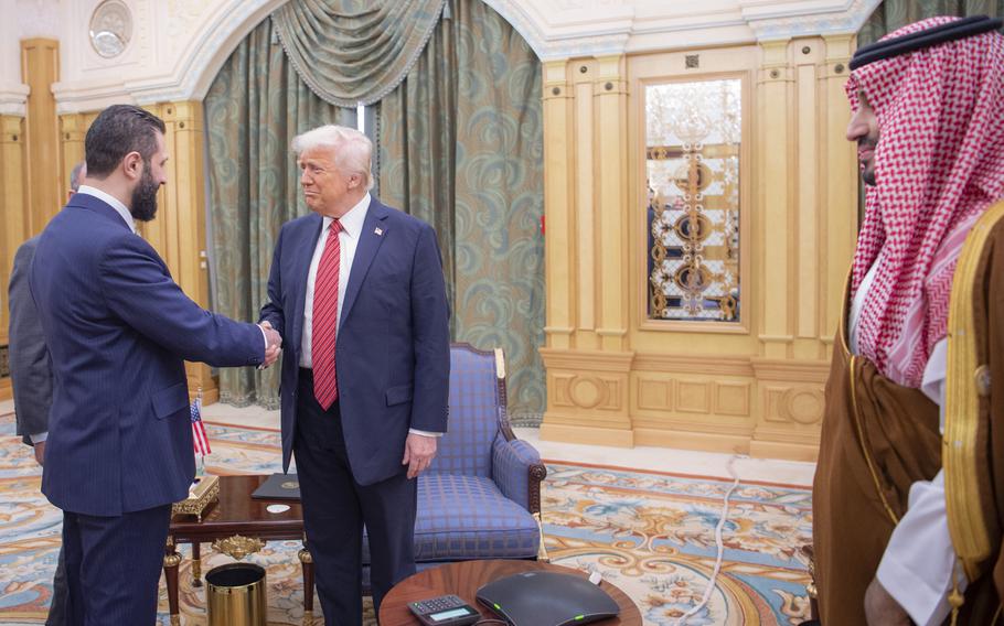 President Trump shakes hands with the interim President of Syria.