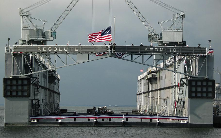 The ensign is lowered for the last time as the floating drydock Resolute (AFDM 10) is deactivated following 58 years of service, Nov. 7, 2003, in Norfolk, Va. Austal USA announced it has been awarded a $128 million contract for the U.S. Navy’s auxiliary floating dry dock medium (AFDM), to be built in Mobile, Ala.