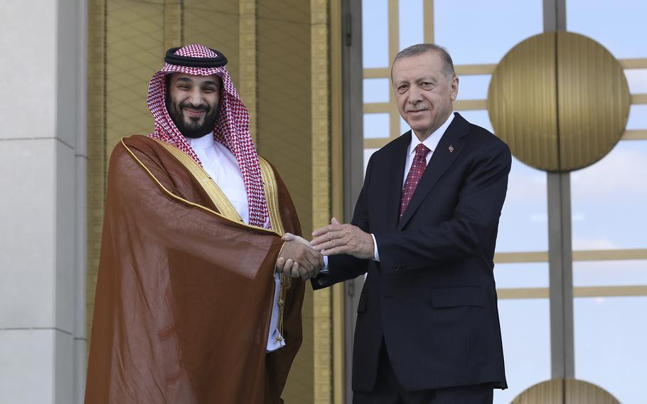 Turkish President Recep Tayyip Erdogan, right, and Saudi Crown Prince Mohammed bin Salman shake hands during a welcome ceremony, in Ankara, Turkey, Wednesday, June 22, 2022. Saudi Crown Prince arrived in Ankara on Wednesday, making his first visit to Turkey following the slaying of Saudi columnist Jamal Khashoggi in Istanbul. Saudi Arabia and Turkey press ahead with efforts to repair ties that were strained by Khashoggi's killing.