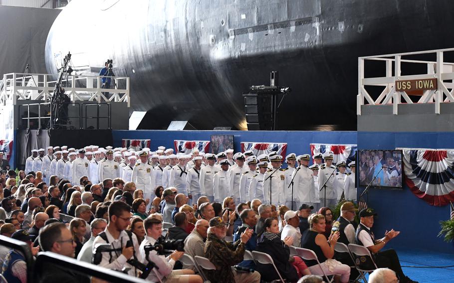 The crew of the pre-commissioning unit USS Iowa (SSN 897) stand in ranks next to their ship during a christening ceremony at General Dynamics Electric Boat shipyard facility in Groton, Conn., Saturday, June 17, 2023. Iowa and crew will operate under Submarine Squadron (SUBRON) 4.