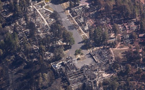 Burned out areas, including trees and structures, from the air.