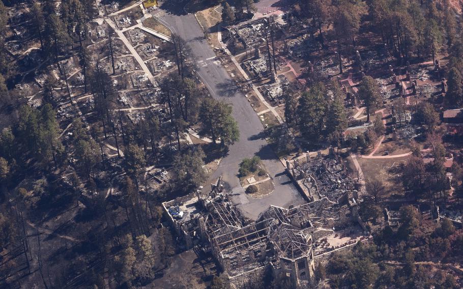 Burned out areas, including trees and structures, from the air.