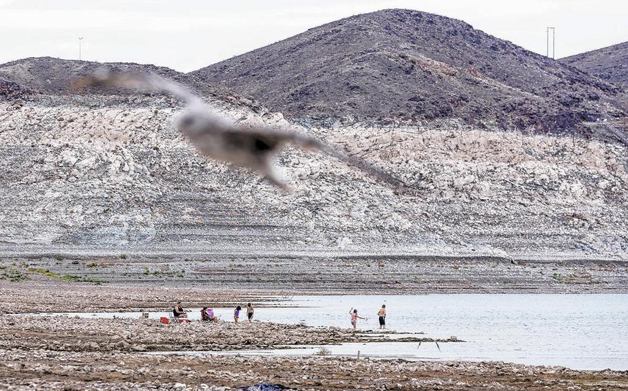 People enjoy Boulder Beach up the waterline where a body was found at Swim Beach within the Lake Mead National Recreation Area on July 26, 2022, near Boulder City. 