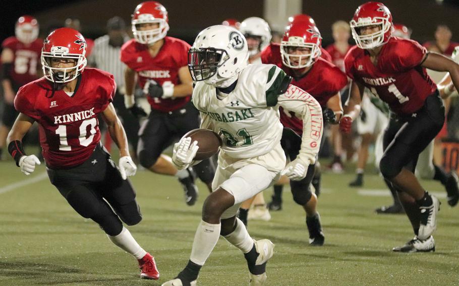 Kubasaki's Malachi Pinkston tries to outrun several Nile C. Kinnick defenders.