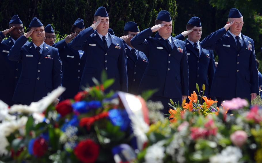 American volunteers from Ramstein Air Base salute during the playing of the French equivalent of taps at the Memorial Day ceremony at Meuse-Argonne American Cemetery in Romagne-sous-Montfaucon, France, in May 2017.