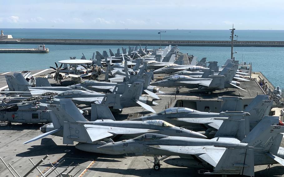 Navy fighters and other aircraft sit on the flight deck of the USS Ronald Reagan during the aircraft carrier's visit to Busan, South Korea, Friday, Sept. 23, 2022. 