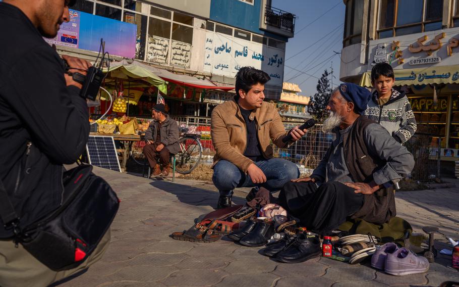 Azrati interviews a man working on shoes in Kabul’s Taimani Project area. M