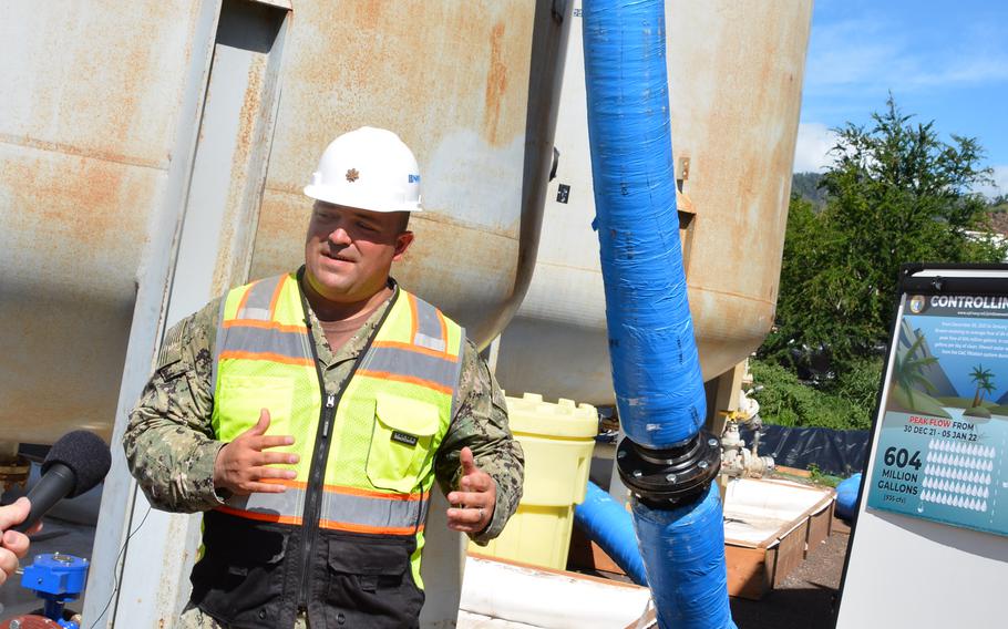 Navy Lt. Cmdr. Travis Myers stands beside a carbon-filter system designed to remove contaminants from water drawn from the Red Hill well on the outskirts of Honolulu, Hawaii, Friday, Jan. 28, 2022.