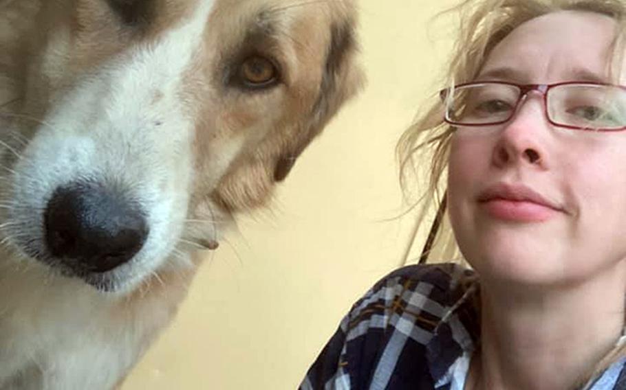 Charlotte Maxwell-Jones poses with a rescue dog at Kabul’s airport on Aug. 29, 2021.