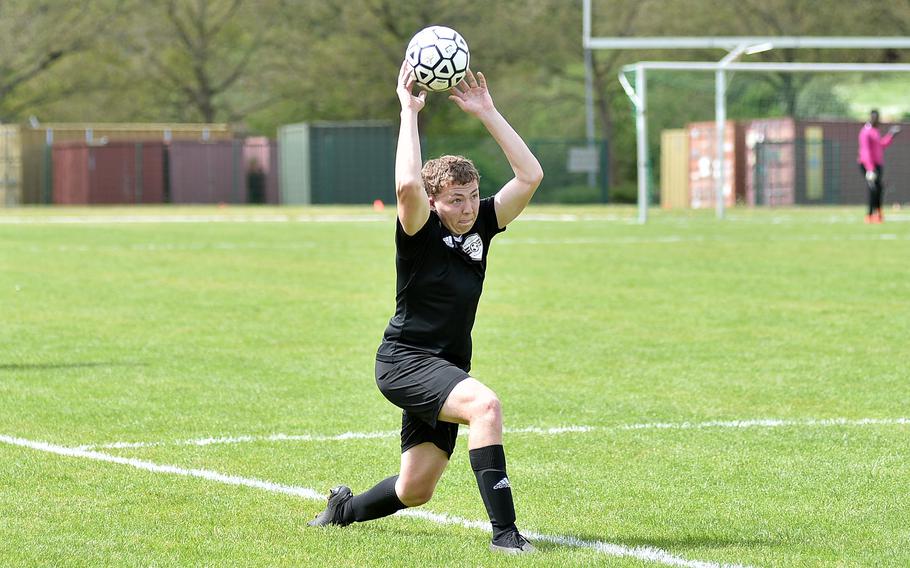 Baumholder midfielder Nick Corbin throws in the ball during a May 4, 2024, match against Brussels at Minick Field in Baumholder, Germany.