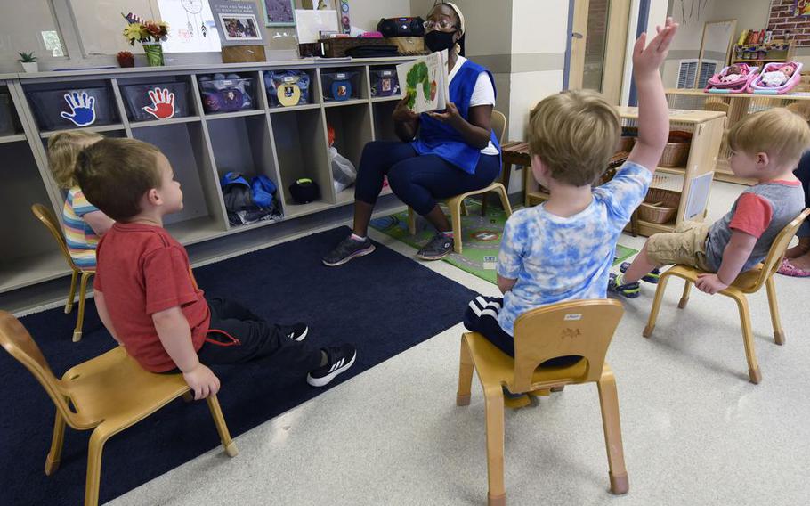 Valissa Williams, assistant teacher, Child Development Center, Wright-Patterson Air Force Base, reads a book to toddlers in August 2020. 