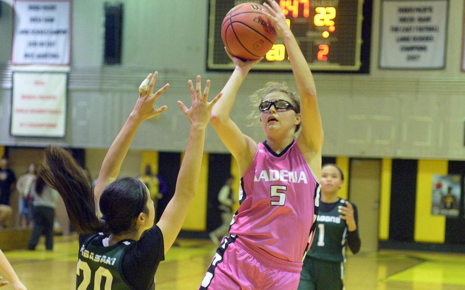 Kadena's Marina Sawyer shoots over Kubasaki's Runa Holladay during Friday's Okinawa girls basketball game. The Dragons won 28-24, giving them a 3-1 season-series edge over the Panthers, their first in 20 seasons.