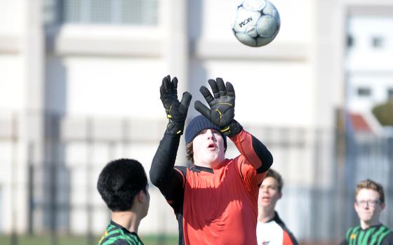 Robert D. Edgren goalkeeper Cole Donnelly draws a bead on a Nile C. Kinnick corner kick during Saturday's DODEA-Japan boys soccer match. The Red Devils shut out the Eagles 7-0.