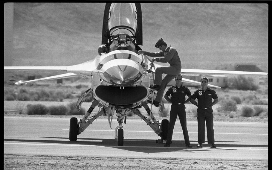 Thunderbird F-16 jets and officers in uniform on Nellis Air Force Base at the biennial Nellis Air Show. The show had more than 130,000 in attendance, one of the largest crowds in the base's history on May 3, 1987. 