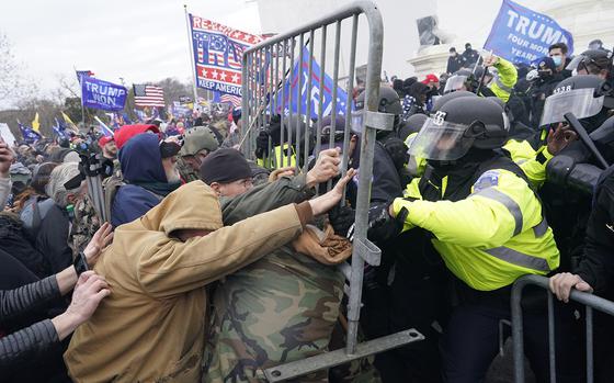 Supporters of Donald Trump try to force their way through a police barricade in front of the U.S. Capitol on Jan. 6, 2021, hoping to stop Congress from finalizing Joe Biden's victory in the 2020 presidential election. (Kent Nishimura/Los Angeles Times/TNS)