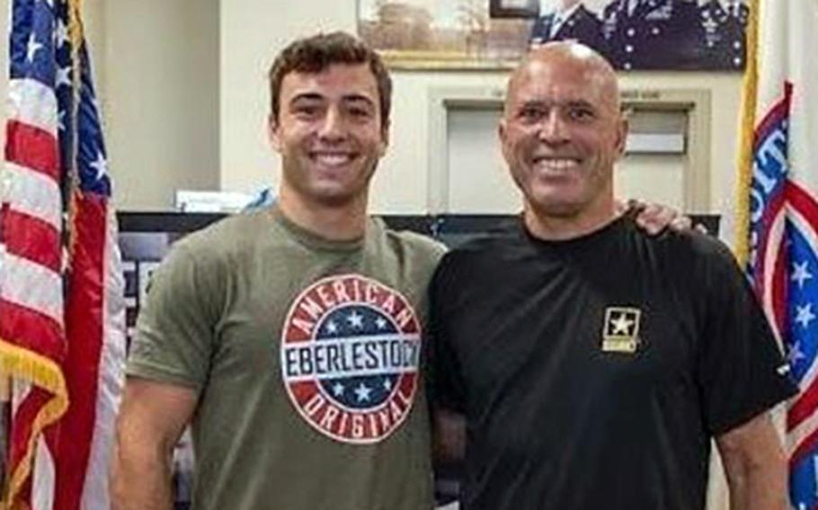 Kheydon Gracie poses with his father, Royce Gracie, the first person inducted into the Ultimate Fighting Championships Hall of Fame, after Kheydon enlisted in the Army at a recruiting office at Huntington Park, Calif.