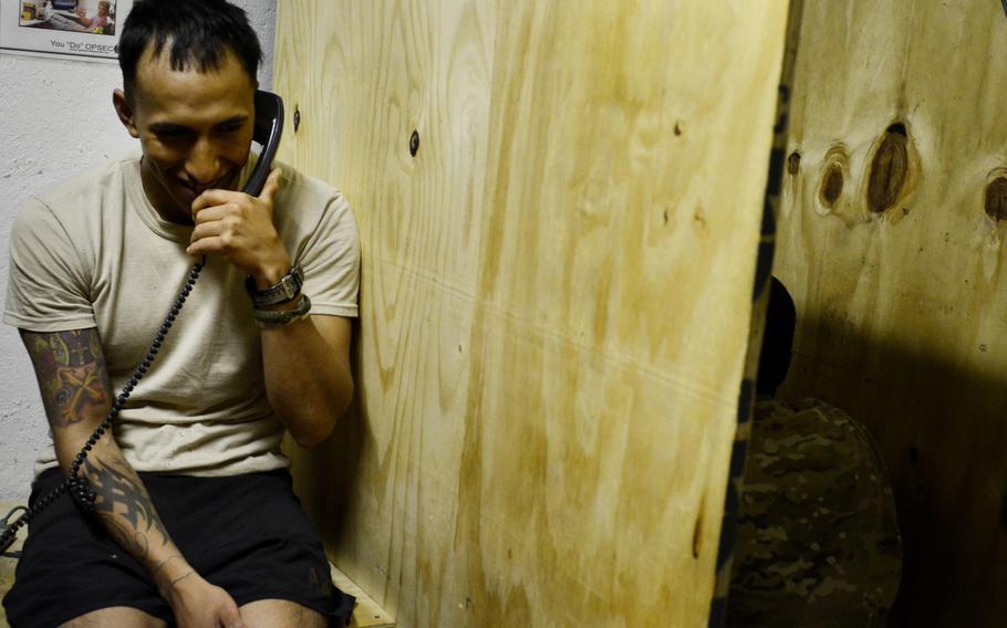 Staff Sgt. Damian Remijio calls his girlfriend in Alaska from the Morale, Welfare and Recreation room at Combat Outpost Sabari, Khost province.