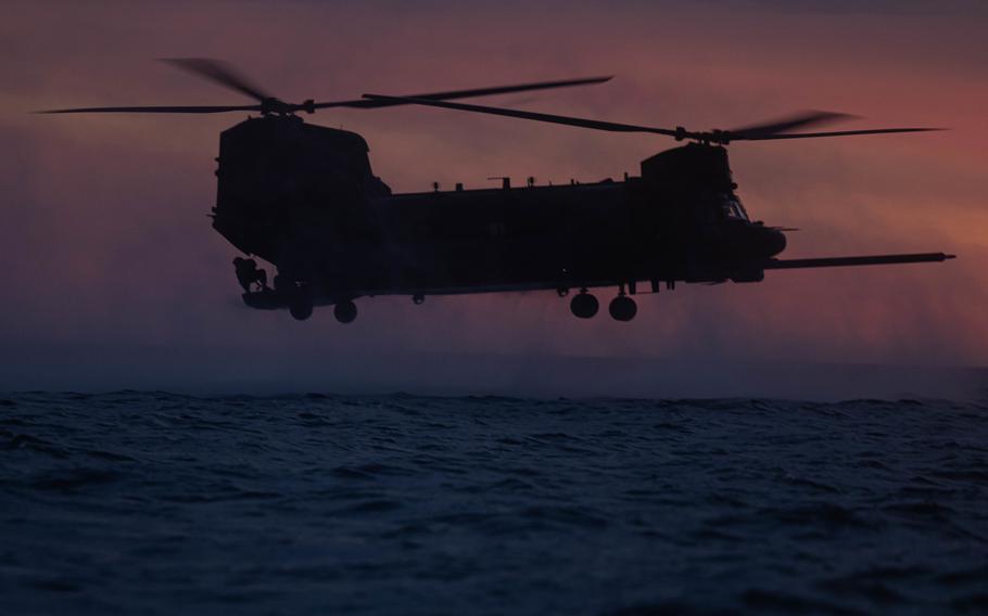 A U.S. Army MH-47 Chinook helicopter with 160th Special Operations Aviation Regiment hovers over the water as part of training with Marines from Bravo Company, 1st Reconnaissance Battalion, 1st Marine Division, during Steel Knight 23 off the coast of Marine Corps Base Camp Pendleton, Calif., Dec. 2, 2022. 