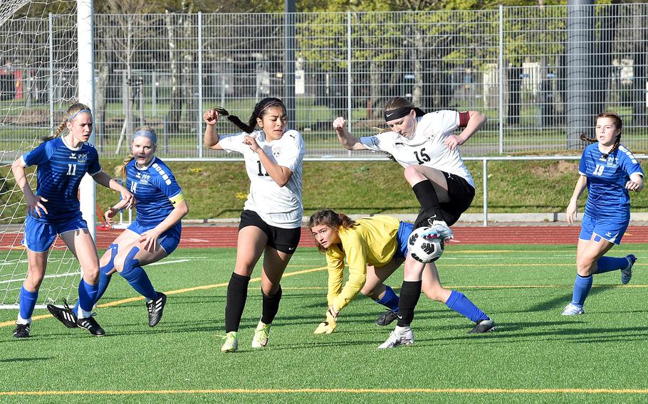 Kaiserslautern's Lena Herrman, center right, tries to get a shot on net as teammate Ulua Villalobos attempts to get out of the way on Friday at Ramstein High School on Ramstein Air Base, Germany. Scrambling in defense are, from left, the Royals' Taylor Laidlaw, Jill Buckley, goalkeeper Liberty Snyder and Kyndra Brown.