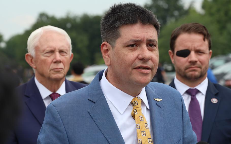 Jonathan Lubecky speaks at a Capitol Hill news conference on the Douglas “Mike” Day Psychedelic Therapy to Save Lives Act, Wednesday, June 14, 2023. Behind him are Reps. Jack Bergman, R-Mich., and Dan Crenshaw, R-Texas.