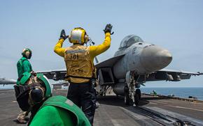 Sailors prepare to launch an F/A-18F Super Hornet fighter jet from the flight deck of aircraft carrier USS Ronald Reagan  in the Arabian Sea, August 2021. One of the biggest risk factors for tinnitus is exposure to loud noises, such as weapons firing, working near loud engines, and combat operations 
