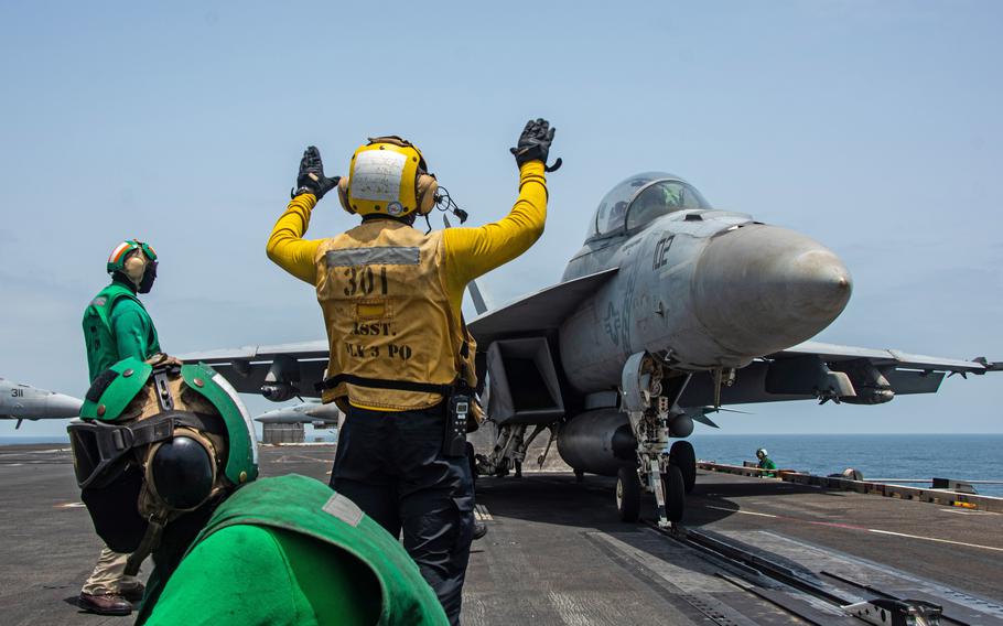 Sailors prepare to launch an F/A-18F Super Hornet from the USS Ronald Reagan in the Arabian Sea in 2021. One of the biggest risk factors for tinnitus is exposure to loud noises, such as weapons fire, engine roar and the explosions common in combat operations. 
