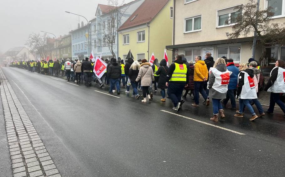 Civilian employees of U.S. bases in Bavaria demonstrate in Grafenwoehr, Germany, Tuesday, Feb. 14, 2023. Union representatives estimate 500 workers joined an early morning demonstration, instead of reporting to work, to demand pay increases.