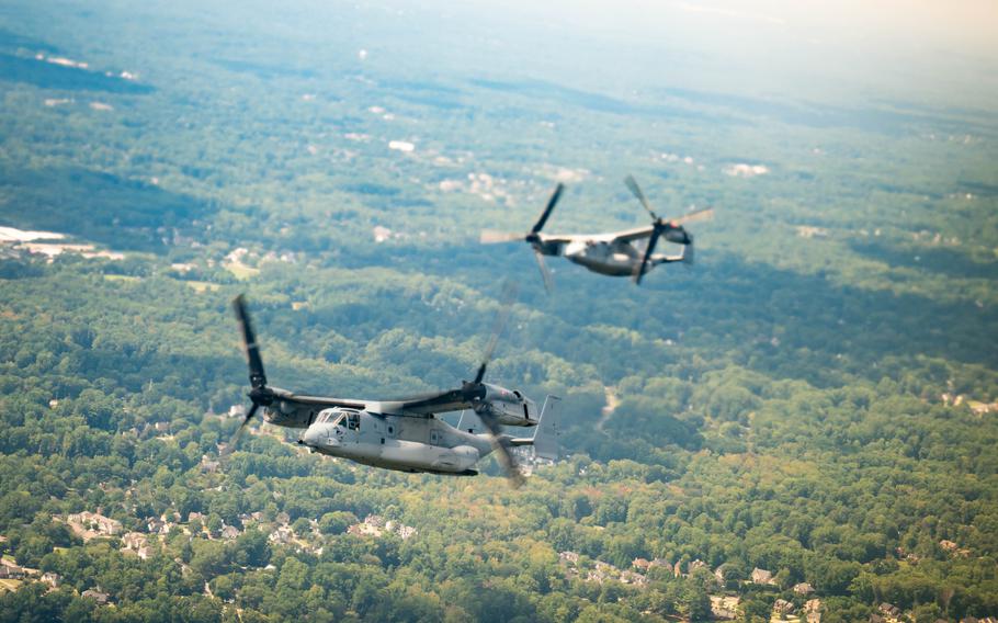 Two aircraft fly together in the sky.
