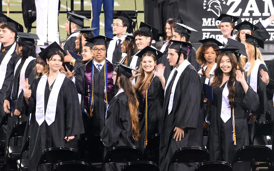 New graduates from Zama Middle-High School wave to their families and friends during their commencement ceremony at Camp Zama, Japan, Wednesday, May 23, 2023. 