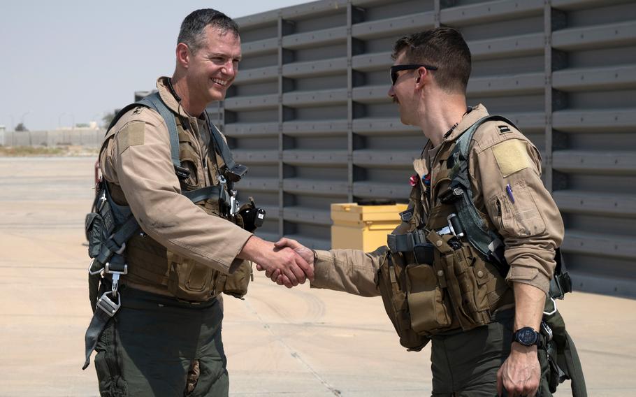 Air Force Lt. Gen. Alexus Grynkewich, Air Forces Central commander, shakes hands with F-16CM pilot Capt. Sean Cahill, 79th Expeditionary Fighter Squadron, after flying a mission together at an undisclosed location in September 2022. 