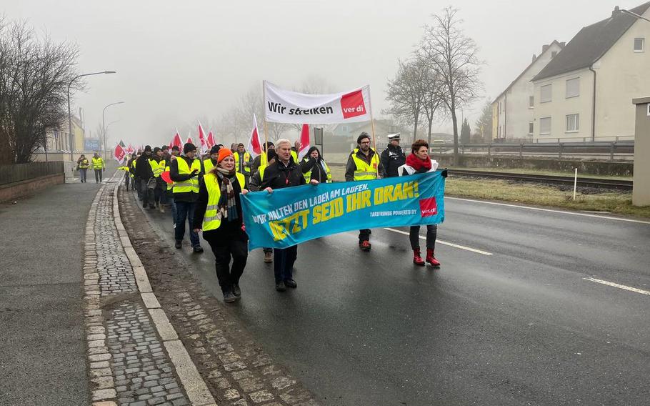 German employees of U.S. military installations in Bavaria walk in protest through Grafenwoehr, Germany, Tuesday, Feb. 14, 2023. Workers union Ver.di said compensation is inadequate in light of a sharply higher cost of living in Europe.