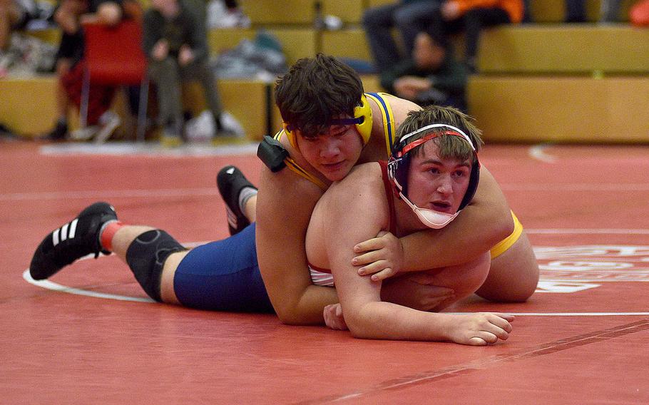 Lakenheath's Gabriel Stanley looks up to his coaches while Wiesbaden's Daniel Garin holds him during a 285-pound match at a wrestling meet on Dec. 9, 2023, at Kaiserslautern High School in Kaiserslautern, Germany.