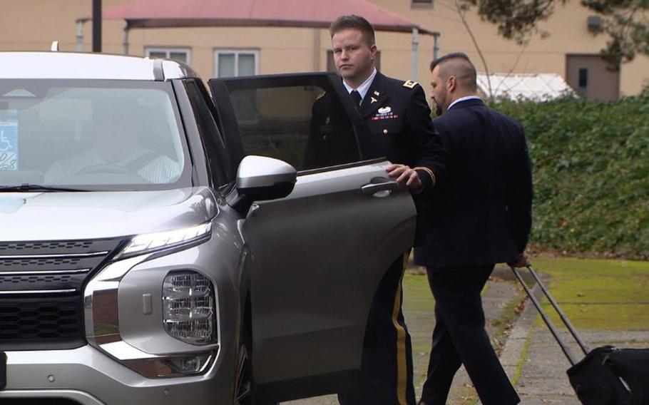 Stockin opens a vehicle door to get in.