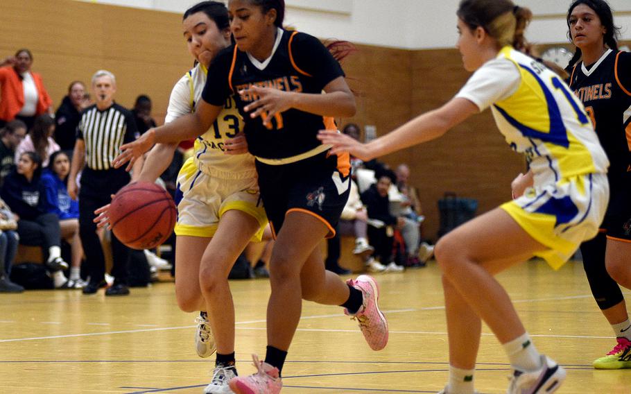 Spangdahlem senior Gabrielle Schmidt fights through a reach by Sigonella junior Alexandra Quintanilla as fellow Jaguar Madison Hoy comes to help during pool-play action on Feb. 15, 2024, at Wiesbaden Middle School in Wiesbaden, Germany.