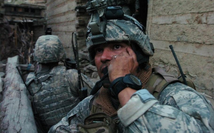 A U.S. Army Soldier calls for an airstrike on the hills surrounding Barge Matal, during Operation Mountain Fire in Afghanistan's eastern Nuristan province, July 12, 2009. 