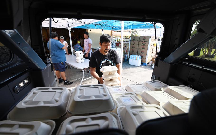 Jose Morales loads up meals Tuesday, Aug. 15, 2023, at Citizen Church in Maui for displaced residents and others unable to get food.