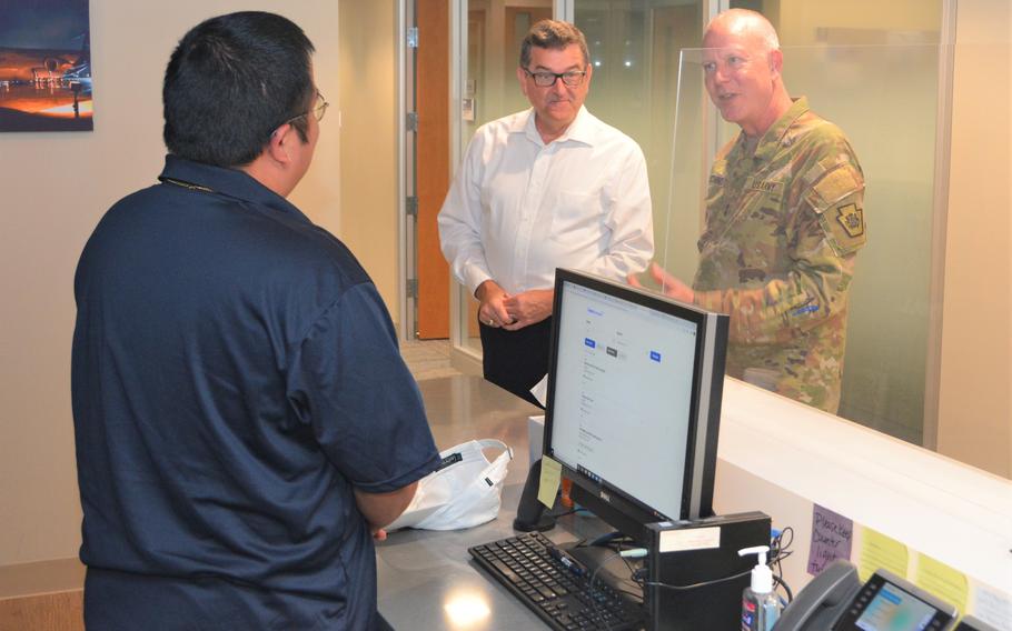 Maj. Gen. Mark Schindler, adjutant general of the Pennsylvania National Guard, right, and Eugene McFeely, Penn State’s senior director for veteran affairs and services, center, talk to a student veteran who works at the Penn State Student Veteran Center at State College, Pa., in September 2022.