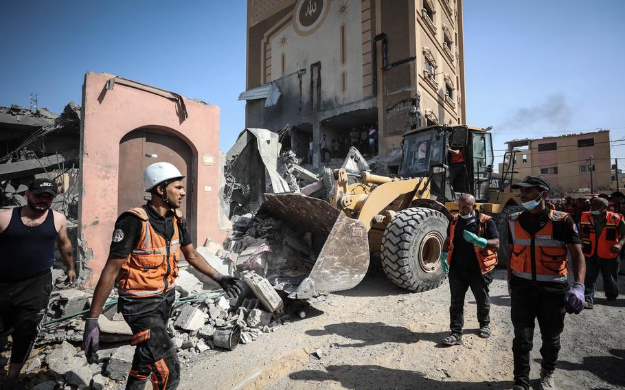 Palestinians look at the aftermath of an airstrike on a house in Khan Younis, south of the Gaza Strip on Friday.