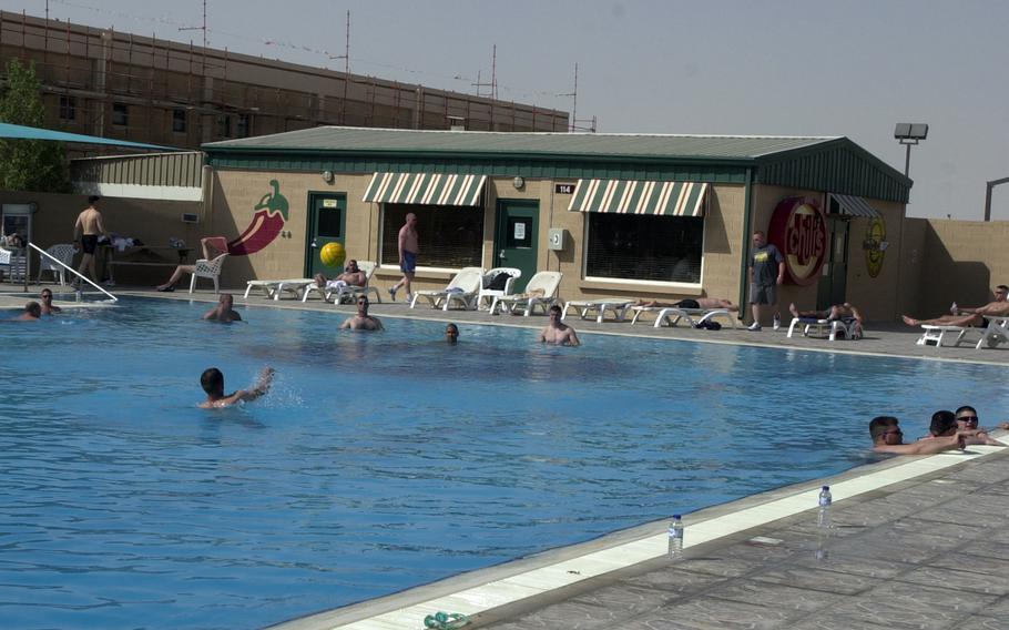 People swim in a pool at Camp As Sayliyah, Qatar, in 2004. The U.S. is planning to house Afghan interpreters and their families at the base, as they wait for asylum in the United States, according to The Wall Street Journal. 