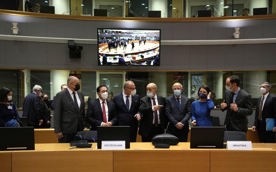 From second left, Spain's Foreign Minister Jose Manuel Albares Bueno, Croatia's Foreign Minister Gordan Grlic Radman, French Foreign Minister Jean-Yves Le Drian, Portugal's Foreign Minister Augusto Santos Silva German Foreign Minister Annalena Baerbock and Slovenia's Foreign Minister Anze Logar during a meeting of EU foreign ministers at the European Council building in Brussels on Monday, Dec. 13, 2021. 