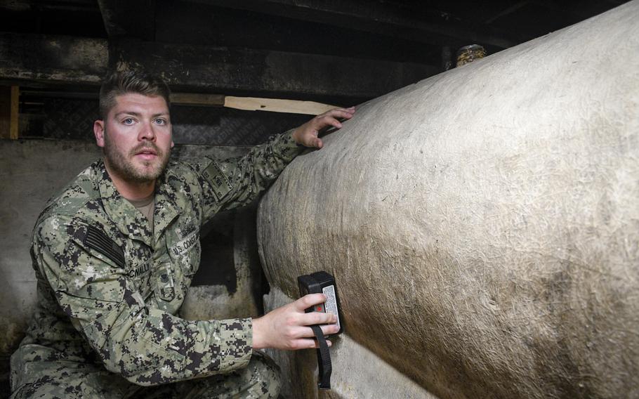 Maritime Enforcement Specialist First Class John McNally shows how he trains sailors to check fuel tanks on boats for hidden compartments used for smuggling, at a training site April 14, 2022 at Naval Support Activity Bahrain in Manama, Bahrain.