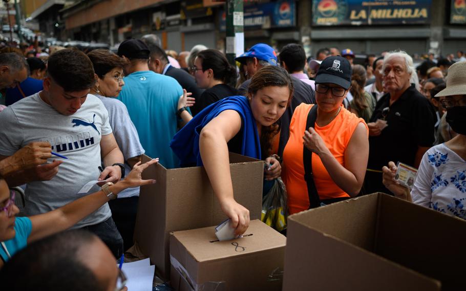 A voter casts a ballot at a polling station during the opposition primaries in Caracas, Venezuela, on Sunday, Oct. 22, 2023.