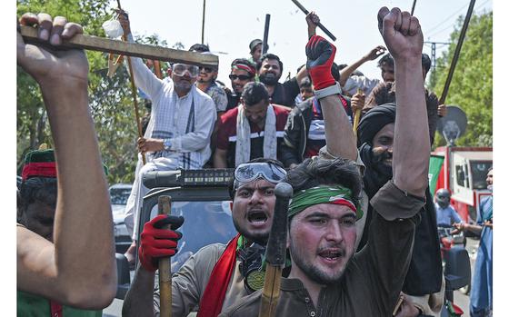 Supporters of former Pakistan's prime minister Imran Khan shout slogans as they march towards Khan's residence in Lahore on March 16, 2023. - Legions of Imran Khan's angry supporters fought off riot police attempting to arrest the former Pakistan prime minister, but the 70-year-old opposition leader insists he is all about law and order. (Aamir Qureshi/AFP via Getty Images/TNS)