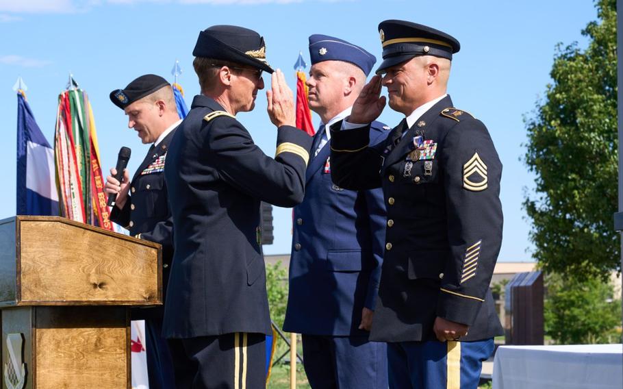Two soldiers salute each other