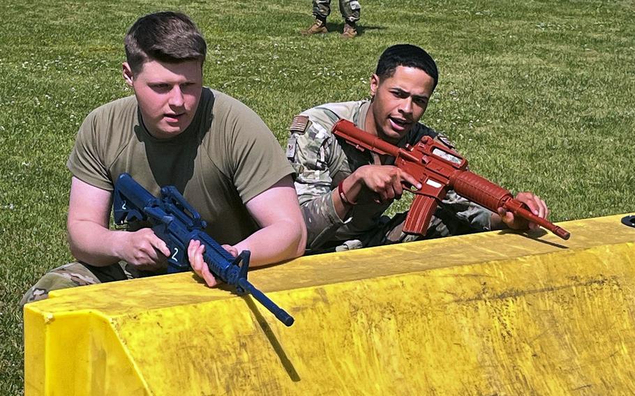 Airman 1st Class Hayden Smith and Senior Airman Kalyn Bake of the 374th Security Forces Squadron take cover during a fire team challenge at Yokota Air Base, Japan, May 17, 2023. 