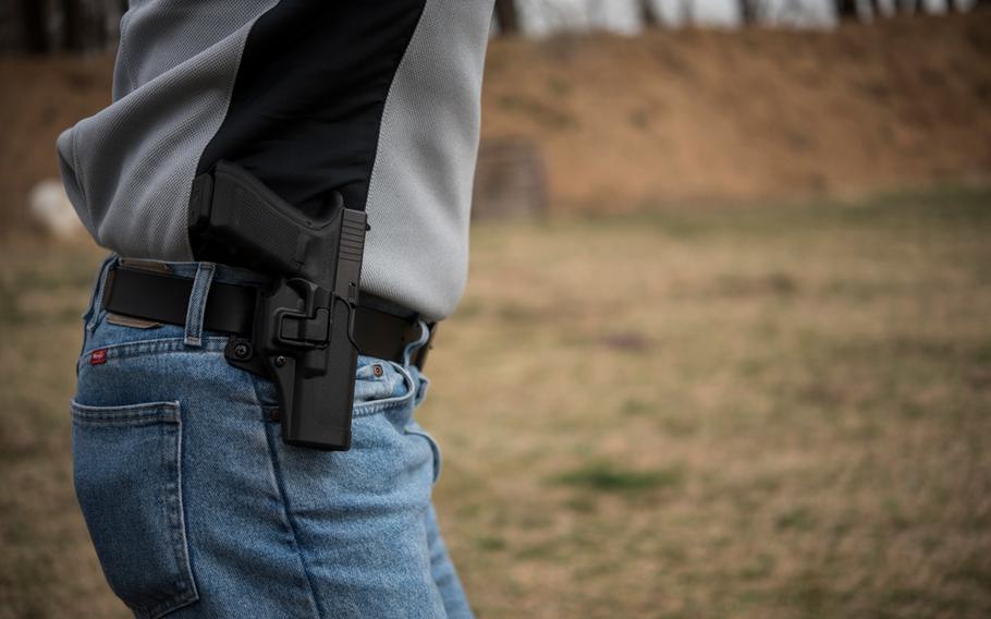 A man is photographed with a gun on March 23, 2018. 