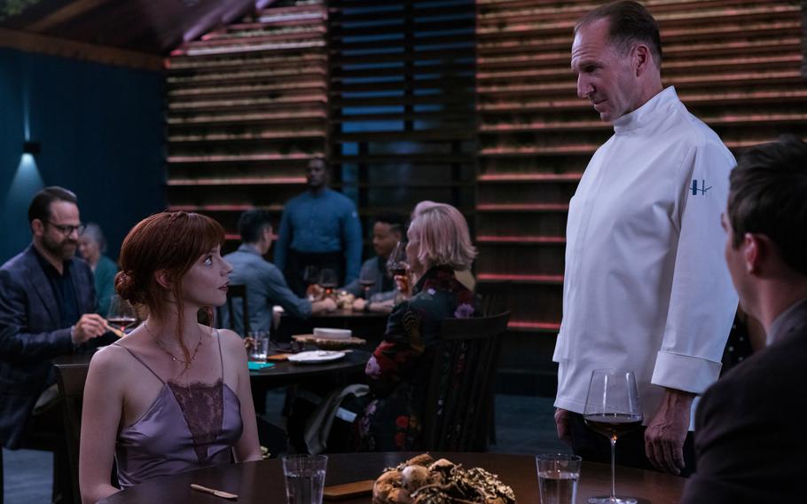 Anya Taylor-Joy, left, is a reluctant guest and Ralph Fiennes is a somewhat tyrannical chef in “The Menu,” now playing at select AAFES theaters. 