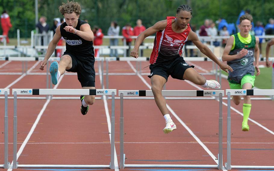 Kaiserslautern’s Sevastian Quiles clears the final hurdle ahead of Jacob Berkau of Hohenfels, on his way to winning the boys 300-meter hurdle race in 41.83 seconds, at the 2025 DODEA-Europe track and field finals in Kaiserslautern, Germany.