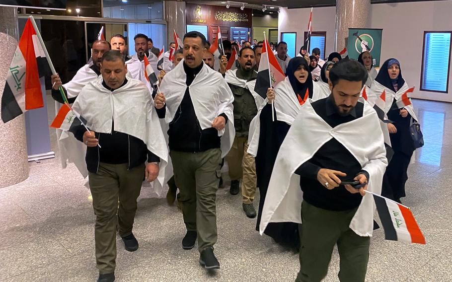 Newly elected lawmakers from the Sadr political bloc prepare to attend the first parliament session, in Baghdad, Iraq, Sunday, Jan. 9, 2022.